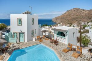 a villa with a swimming pool and the ocean at Santanna Suites in Patmos