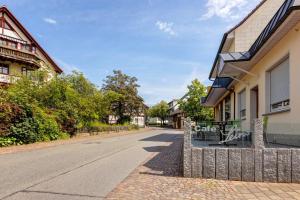 a street in a town with houses and a fence at Seeapartment Höri in Gaienhofen