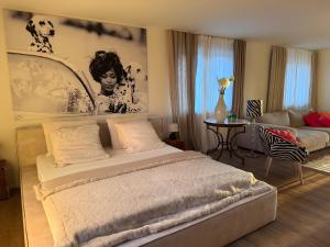 a bedroom with a large bed and a living room at Seeapartment Höri in Gaienhofen