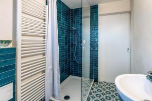 a bathroom with a glass shower and a sink at Seeapartment Höri in Gaienhofen +12 photos