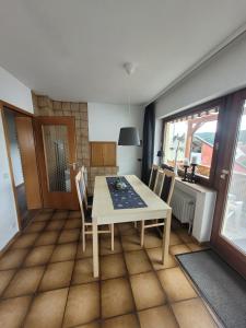 ein Esszimmer mit Tisch und Stühlen und einem Fenster in der Unterkunft Am Strohberg in Petersburg