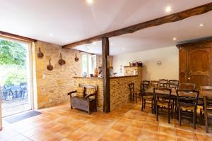 a dining room with a table and chairs at Maison en pierre piscine clim in Varennes