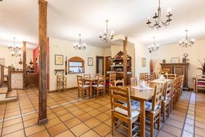 a dining room with a table and chairs at La Cárcava in La Serna del Monte