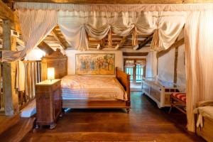 a bedroom with a canopy bed and a dresser at Maison De Charme Avec Jacuzzi in Arcangues