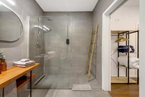a bathroom with a shower with a glass door at Jm Stay in Aveiro