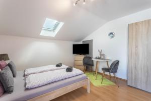 a bedroom with a bed and a table with chairs at Apartment Bergblick in Frasdorf +8 photos