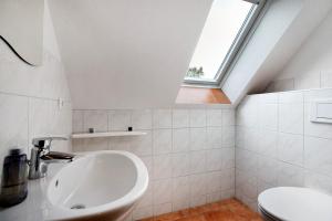 a bathroom with a sink and a toilet at Ferienwohnung Coni in Langballig +28 photos