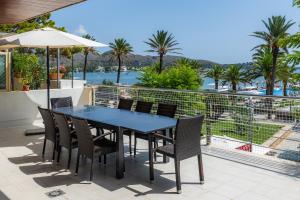 a table and chairs on a balcony with a view of the water at Olympo in Port de Pollensa