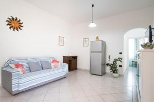 a living room with a couch and a refrigerator at Villa Sa Mela 28 in Orosei