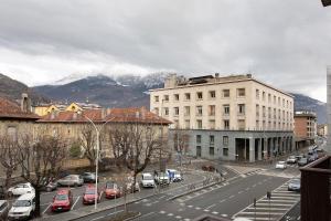 a city street with cars parked in front of a building at Double room - Myaostaproject in Aosta