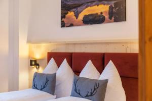 a close up of a bed with white pillows at Apartment Bergglück Stummerberg in Stummerberg