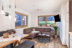 a living room with a couch and a table at Apartment Bergglück Stummerberg in Stummerberg