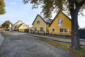 a yellow house on the side of a street at Ferienwohnung Sophie in Lauchhammer