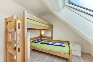 a small bedroom with bunk beds in a attic at Haus Kasberger in Ascheberg