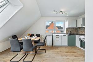 a kitchen and dining room with a table and chairs at Haus Kasberger in Ascheberg