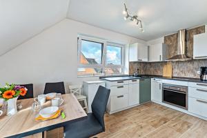 a kitchen with a table and a dining room at Haus Kasberger in Ascheberg +17 photos