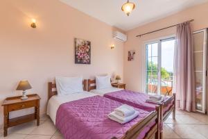 a bedroom with two beds and a window at Even Ezer with private pool in Pouládes +21 photos