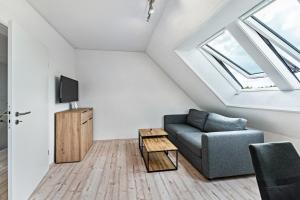 a living room with a couch and a tv at Haus Kasberger in Ascheberg