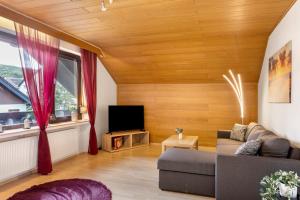 a living room with a couch and a tv at Ferienwohnung Schliestädt in Wellerode