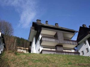 a building on top of a hill with a blue sky at Ferienwohnung Nordenau in Schmallenberg