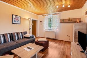 a living room with a couch and a table at Ferienwohnung Gruber in Bodenwöhr