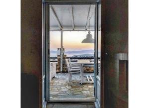 a view of a table and chair from a window at Villa Galazio in Kampos Paros