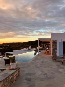 a villa with a swimming pool and a house at Villa Galazio in Kampos Paros
