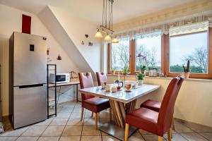 a kitchen with a table and a refrigerator at Ferienwohnung 'am Weidenring' in Pantelitz