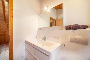 a bathroom with a sink and a mirror at Bergchalet Refugium Martius in Marlengo