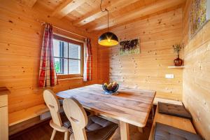 a dining room with a wooden table and chairs at Bergchalet Refugium Martius in Marlengo +21 photos