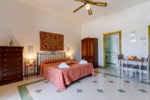 a bedroom with a bed and a ceiling fan at Domus mea salento Arazzo Rosso in Ugento