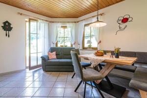 a living room with a table and a couch at Springhansenhof in Oppenau +35 photos