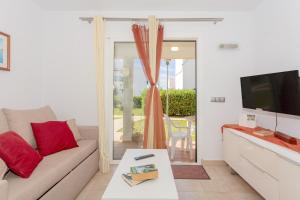 a living room with a couch and a tv at Lurdes in Ciutadella