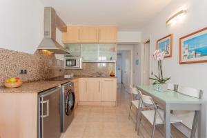 a kitchen with a table and a counter top at Lurdes in Ciutadella