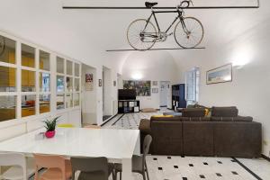 a bike hanging from a ceiling in a living room at Casa Meloria in Finale Ligure