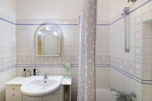 a white bathroom with a sink and a shower at Casa Meloria in Finale Ligure +25 photos