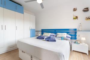 a blue and white bedroom with a large bed at Casa Del Caballero Corralejo in Corralejo +17 photos