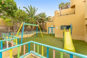 a playground with a slide in a building at Casa Del Caballero Corralejo in Corralejo