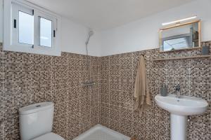 a bathroom with a toilet and a sink at Casa Los Pinos in Chinamada +21 photos