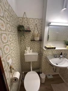 a small bathroom with a toilet and a sink at Schmuckkästle in Sasbachwalden +17 photos