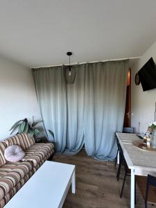 a living room with a couch and a table at Schmuckkästle in Sasbachwalden