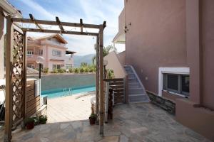 a external view of a house with a swimming pool at Villa Dionysia Studio 10 in Alikanas