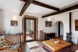 a living room with a wooden table and a door at The Gallery - Unità 16 in Baiardo +20 photos