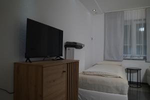 a television on a wooden stand in a room at Dreams im Erdgeschoss in Koetz 