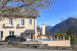 a house with a car parked in front of it at Chambres d'hôtes - Chez Antho in Betton-Bettonet