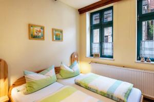 a bedroom with two beds and two windows at Fewo Altstadtkern Waren Müritz in Waren