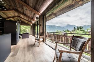 a kitchen and living room with a view of mountains at Chalet Bella in Essert-Romand