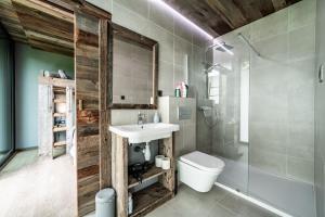 a bathroom with a sink and a toilet at Chalet Bella in Essert-Romand +32 photos