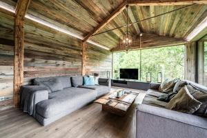 a living room with a couch and a table at Chalet Bella in Essert-Romand