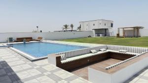 a large swimming pool with a couch and a couchituresitures at Al REEF in Billah